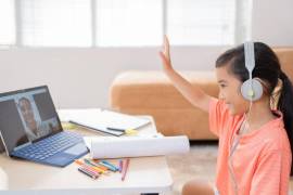 Asian girl Studying online with her teacher greeting